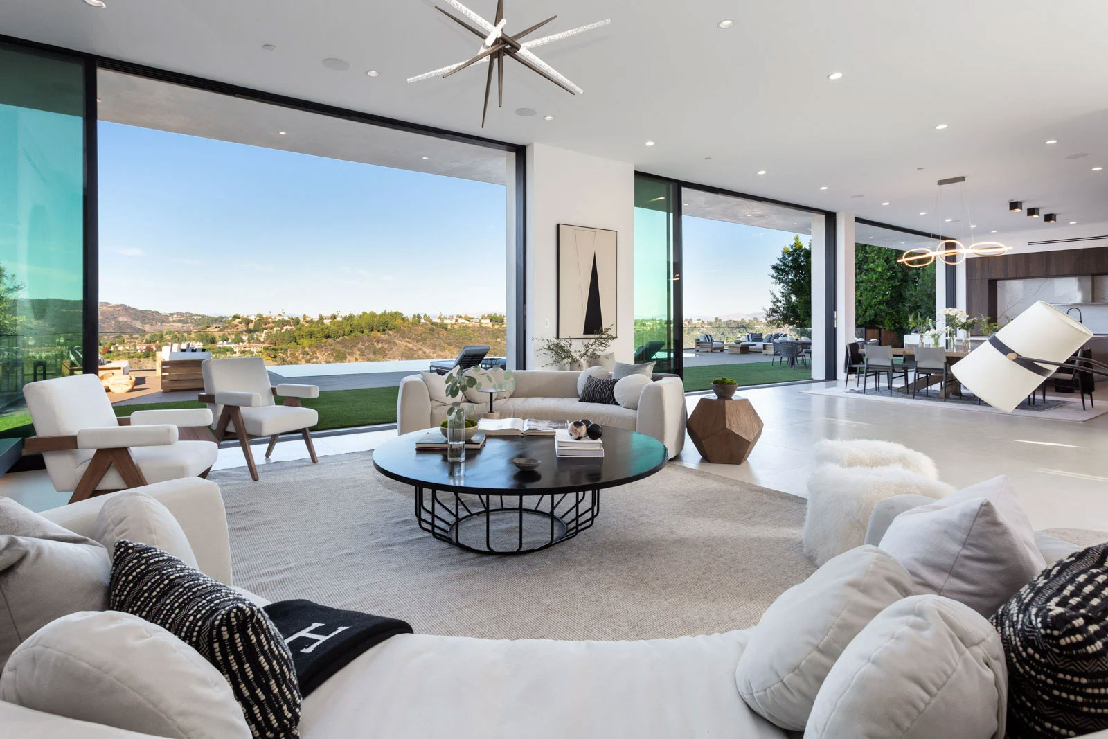 living room with white furniture and view of hills